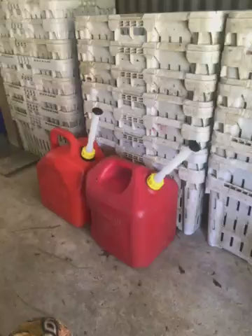 Pouring demo of the Kool Products flexible gas can spout on two red gas cans